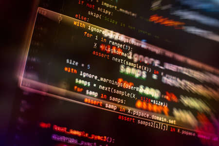 Software source code. Programming code. Programming code on computer screen. Developer working on program codes in office.の写真素材