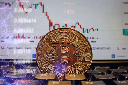 Gold bitcoins with Candle stick graph chart and digital background. Golden coin with icon letter B....