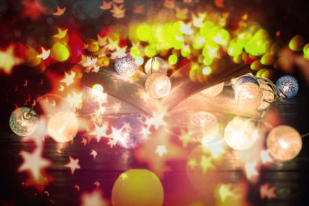 fantasy reading magical image of open antique book over wooden table with glitter overlay.の写真素材