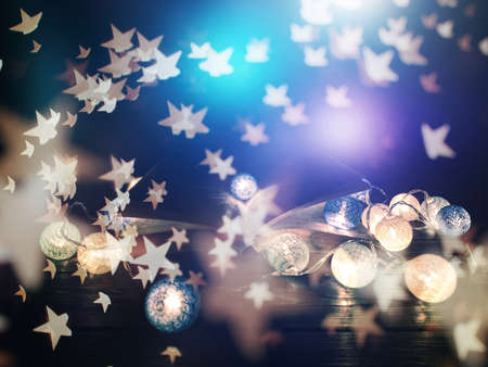 fantasy reading magical image of open antique book over wooden table with glitter overlay.の写真素材