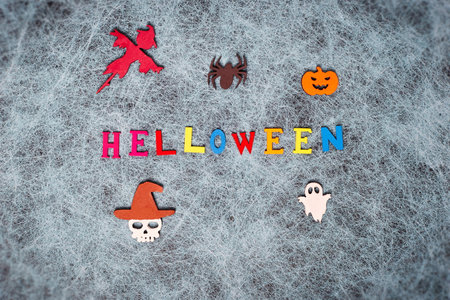 Holiday helloween on a spider web background with a white leaf, pumpkin, ghost, scarecrow, skull, witchの写真素材