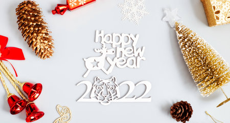 Christmas composition of spruce branches, gift, cinnamon, anise and confetti stars on rustic wooden...