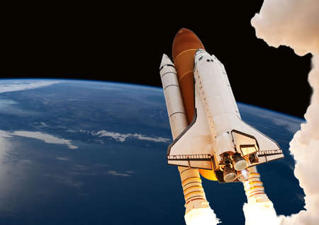 spaceship takes off into the night sky on a mission.Elements of this image furnished