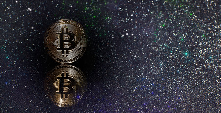 bitcoins with Candle stick graph chart and digital background. Golden coin with icon letter B. Mining or blockchain technologyの写真素材