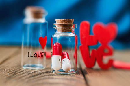 Love medicine. I love you .Tablets in jars are kissing, Happy Valentine's Day, Mother's Day, March 8, World Women's Day holiday card concept.の写真素材