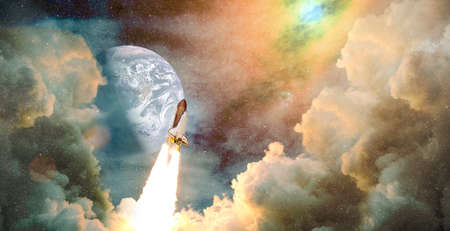 Shuttle launch in the clouds to outer space. Dark space with stars on background.Spaceship flight. Elements of this image furnishedの写真素材