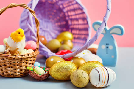 Easter colored eggs in a basket pink background. minimal concept. Card with copy space for text....