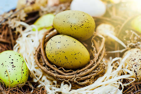 Easter background with colorful eggs in nest. top view with copy space