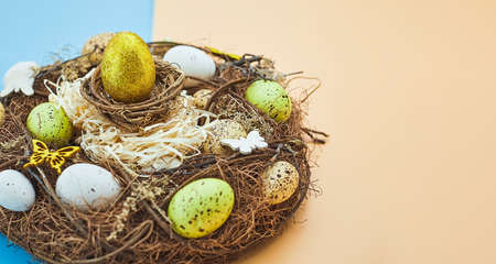 Easter background with colorful eggs in nest. top view with copy space