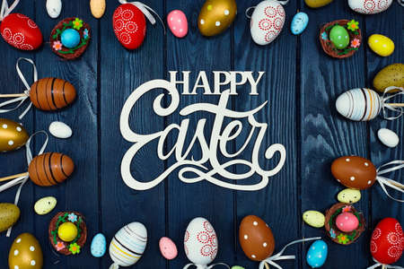 Easter eggs on wooden background. Blue wooden background. The minimal concept. top view. Card with a...