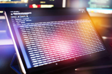 modern tech. PHP syntax highlighted. Writing programming functions on laptop. Big data and Internet...