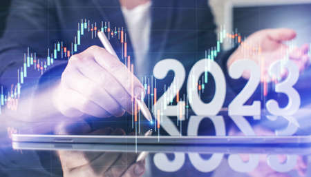 Hand write on tablet and touch screen. Stock market 2023 concept. businessman trader looking at...