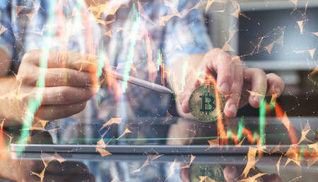 The man is holding a bitcoin coin. Businessman puts in bitcoin. The concept of buying bitcoins....
