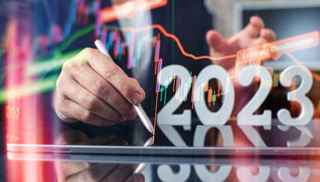 Hand write on tablet and touch screen. Stock market 2023 concept. businessman trader looking at chart analysis candleの写真素材