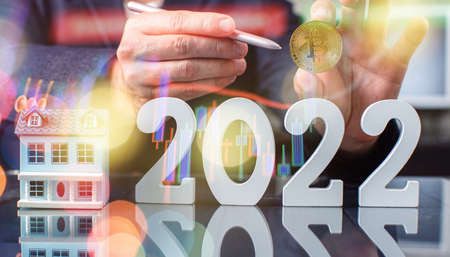 Businessman Hand holding bitcoin with pen as part of business network on 2022 background. bitcoin...