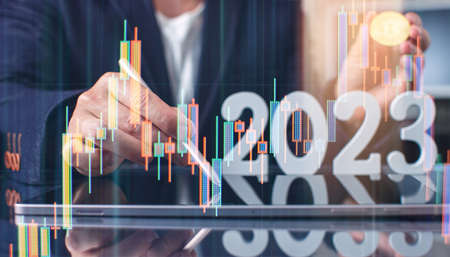 The man is holding a bitcoin coin 2023. Businessman puts in bitcoin. The concept of buying bitcoins. preservation. Cryptocurrency. close-up. virtual moneyの写真素材