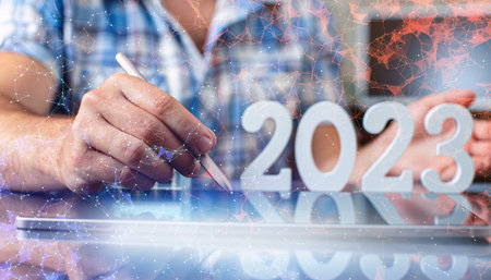 Hand write on tablet and touch screen. Stock market 2023 concept. businessman trader looking at...