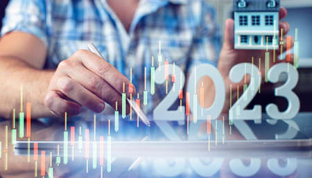Hand write on tablet and touch screen. Stock market 2023 concept. businessman trader looking at...