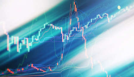 Charts of financial instruments with various types of indicators including volume analysis for professional technical analysis on the monitor of a computer.の写真素材