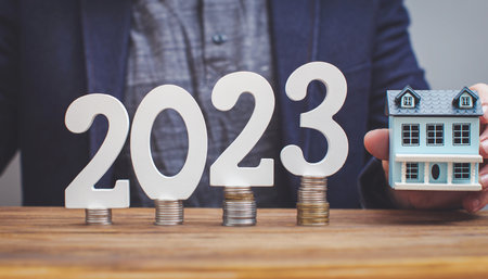analyzes real estate profitability with augmented reality digital graphics, positive performance in 2023, businessman calculates financial data for long term investment.の写真素材