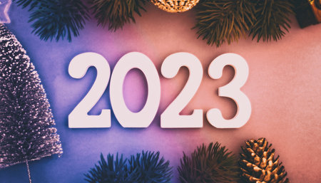 New Year 2023 background with Christmas balls and fir branches. Abstract christmas lights on background.の写真素材