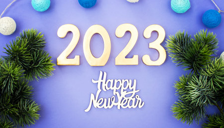Happy New Year 2023. A symbol from the number 2023 with Golden balls, stars, sequins and a beautiful bokeh . The concept of the celebration.の写真素材