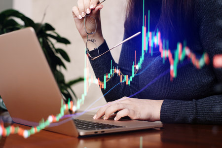 Businesswoman working with laptop on wooden desk, stock