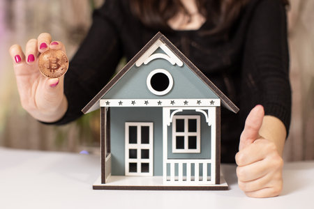 Businesswoman reflects on investing profits in bitcoin or realの写真素材