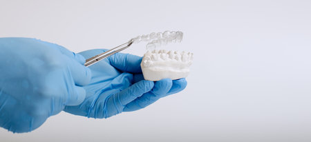 Orthodontic dental theme on blue background.Transparent invisible dental aligners or braces aplicableの写真素材