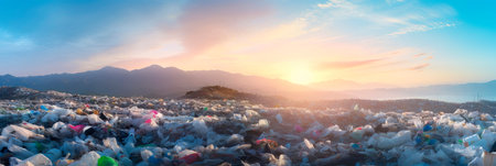 sprawling landfill site overflowing with mountains of discarded plastic waste, highlighting the issue of plastic pollution.の素材