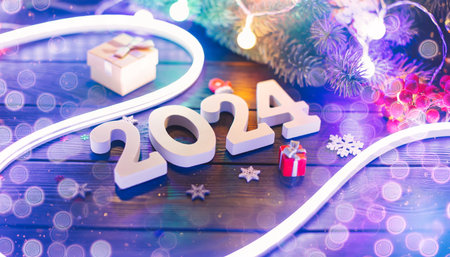 new year 2024 card Banner snowfall on a woodenの写真素材