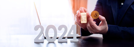 businessman buys gold and bitcoin in 2024 using digital technology and laptop computer.の写真素材
