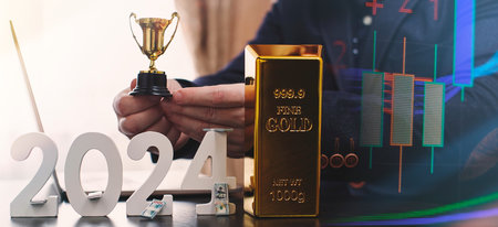 businessman buys gold using digital technology and laptop computer with forex chart and candlestick chart on screen. Finance and trade concept.の写真素材