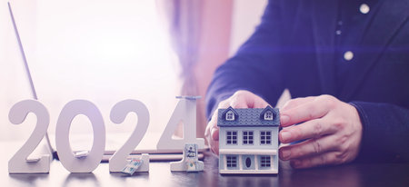 businessman buying property in 2024 using digital technology and laptop computer. Finance and trade...