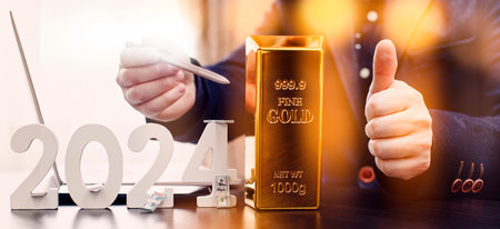 businessman buys gold using digital technology and laptop computer with forex chart and candlestick chart on screen. Finance and trade concept.の写真素材