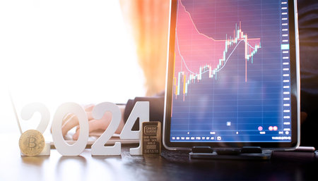 businessman buys gold and bitcoin in 2024 using digital technology and laptop computer.
