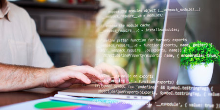 Programmer working with a computer in the office. Close-up of a man's hands typing on a keyboard. Abstract ITの写真素材