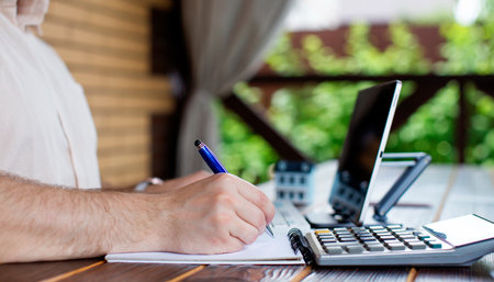 businessman uses tablet to record expenses for planning advertising marketing strategies for SEO,...