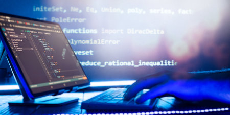 Abstract software development concept with code and laptop on blurred background representing...