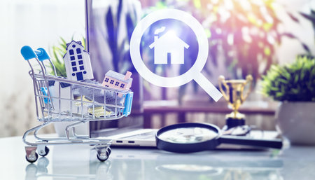 Miniature Houses in Shopping Cart with House Icon Symbolizing Property Selection, Digital Market Research, and Investment Successの写真素材