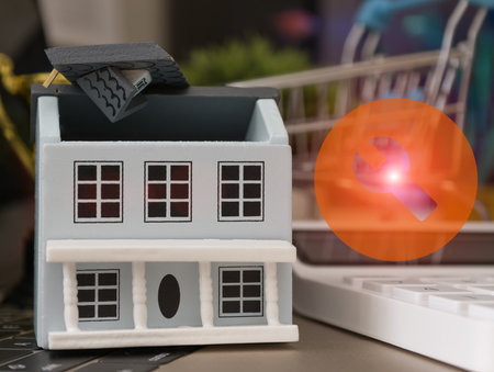 Miniature model house with open roof and wrench icon symbolizing property repair, renovation, or...
