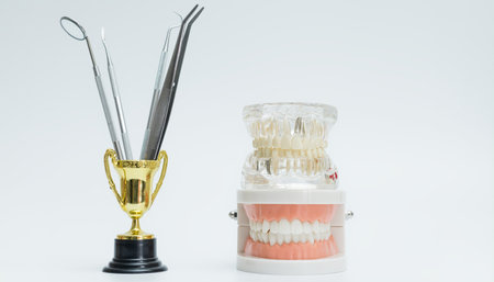 Creative dental display featuring a trophy holding instruments, next to realistic denture and...