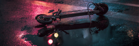 Modern electric scooter fallen on a wet asphalt road with dramatic lighting and reflections, symbolizing accident, urban life. Generative AIの素材