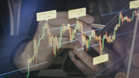 Close-up of a person using a smartphone and stylus for stock trading, overlaid with a live...