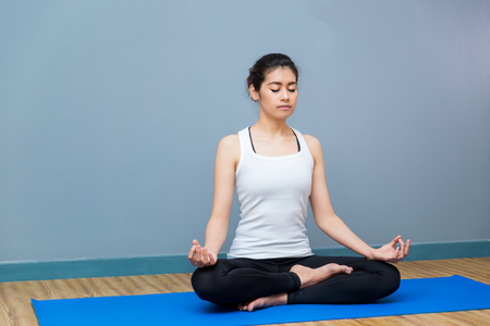 Asian young woman practicing yoga in the room and sport yoga,yoga in the room,sport yoga,yoga practice,yoga relaxの写真素材