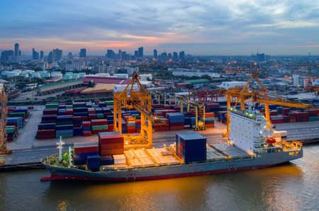 Containers yard in port congestion with ship vessels are loading and discharging operations of the transhipments in international port.のeditorial素材