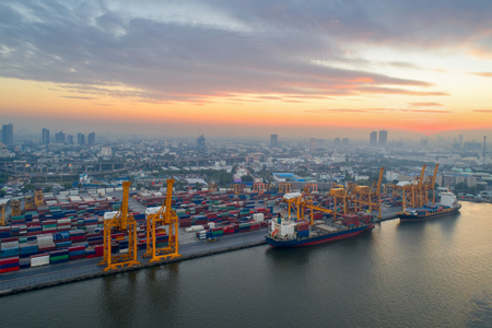 Aerial view of Containers yard in port congestion with ship vessels are loading and discharging operations of the transportation in international port.Shot from drone.のeditorial素材