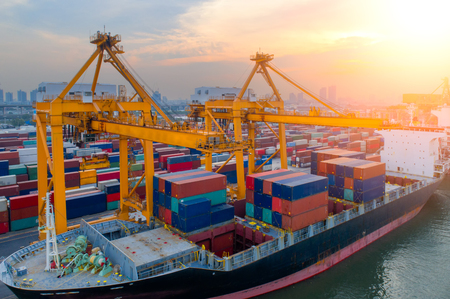 Aerial view of Containers yard in port congestion with ship vessels are loading and discharging operations of the transportation in international port.Shot from drone.のeditorial素材