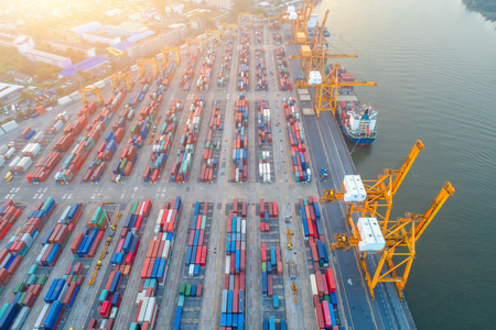 Containers yard shot from drone in port congestion with ship vessels are loading and discharging operations of the transportation in international port.のeditorial素材