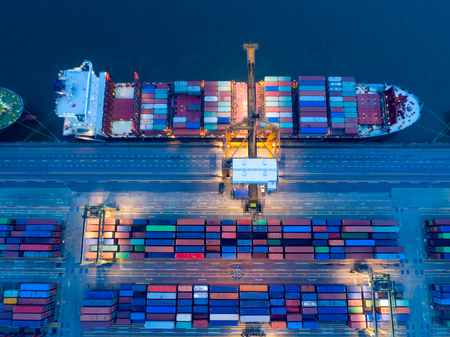 Containers yard in port congestion with ship vessels are loading and discharging operations of the...